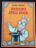 The front cover of the children's book 'An Arthur Adventure' by Marc Brown, titled 'Arthur's April Fool', featuring a cartoon illustration of Arthur the rabbit in a magician's hat on a warm orange background.