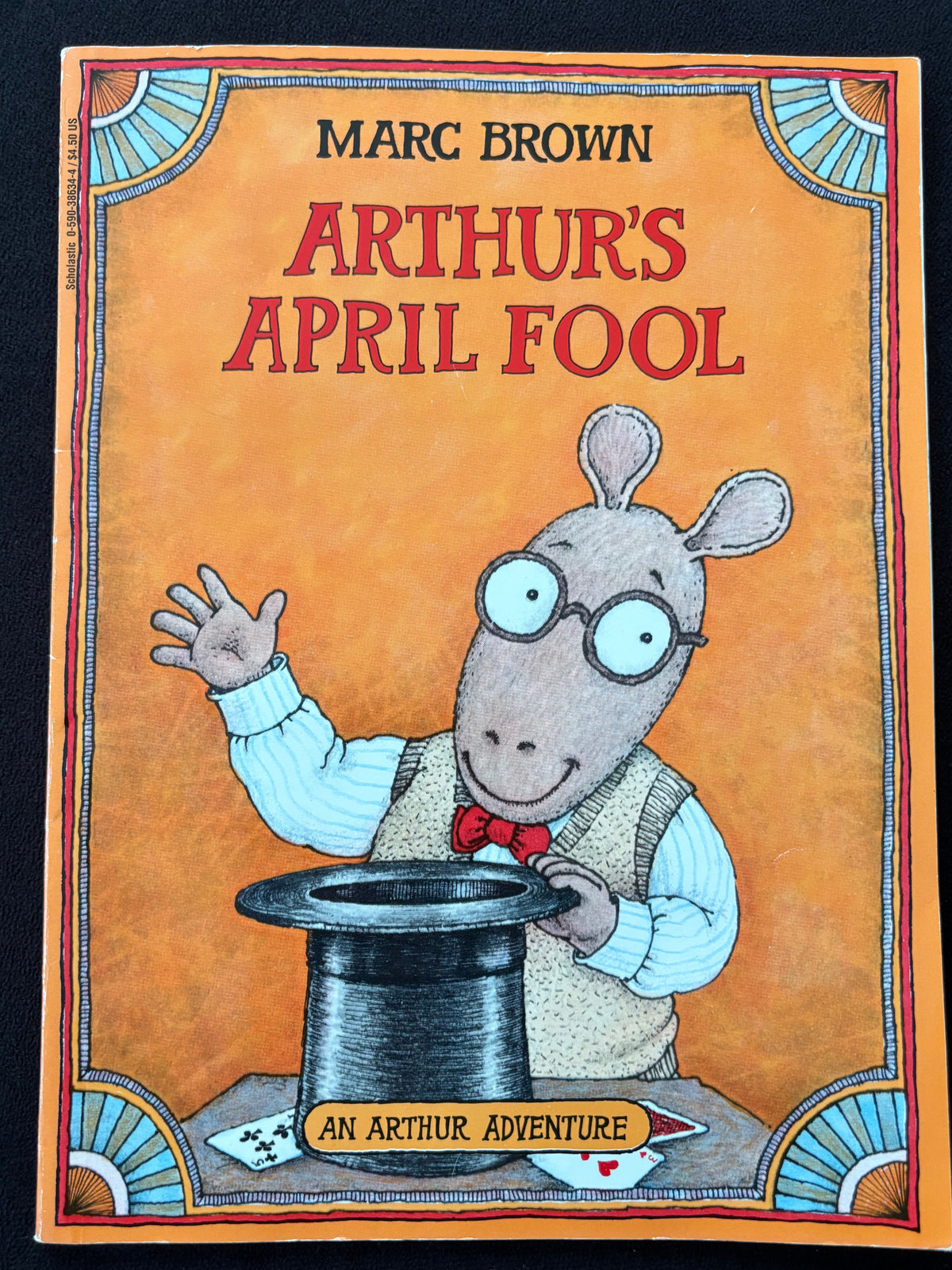 The front cover of the children's book 'An Arthur Adventure' by Marc Brown, titled 'Arthur's April Fool', featuring a cartoon illustration of Arthur the rabbit in a magician's hat on a warm orange background.