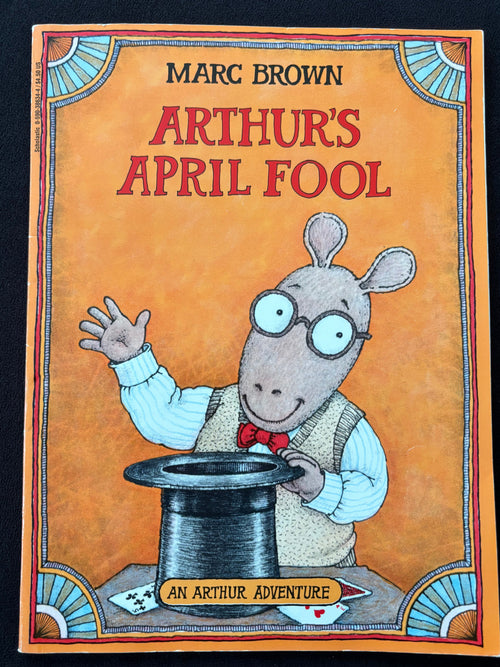 The front cover of the children's book 'An Arthur Adventure' by Marc Brown, titled 'Arthur's April Fool', featuring a cartoon illustration of Arthur the rabbit in a magician's hat on a warm orange background.